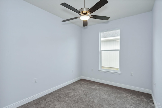 carpeted empty room with plenty of natural light, a ceiling fan, and baseboards