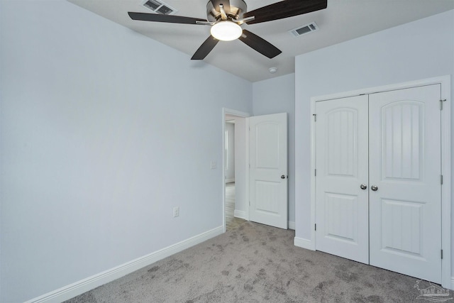 unfurnished bedroom featuring a closet, baseboards, visible vents, and carpet floors