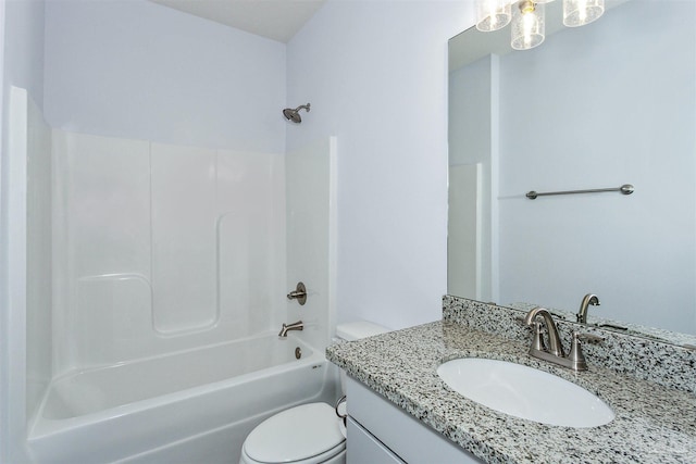 bathroom with toilet, vanity, and  shower combination