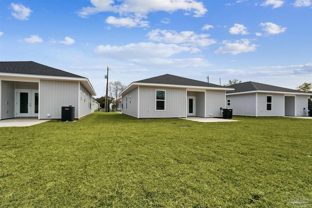 back of property with french doors, a yard, central AC unit, and a patio area