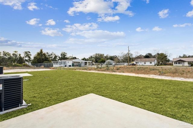 view of yard featuring a patio area, central AC unit, and fence