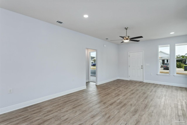 unfurnished room featuring recessed lighting, visible vents, baseboards, and wood finished floors