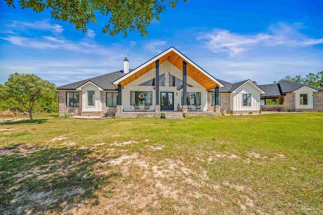 3720 Arbor Ridge Rd, Pace, FL 32571 - rear view of property with french doors, board and batten siding, a chimney, and a yard
