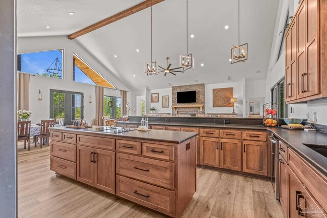 3720 Arbor Ridge Rd, Pace, FL 32571 - kitchen with light wood-style floors, electric stovetop, dark countertops, beam ceiling, and an inviting chandelier