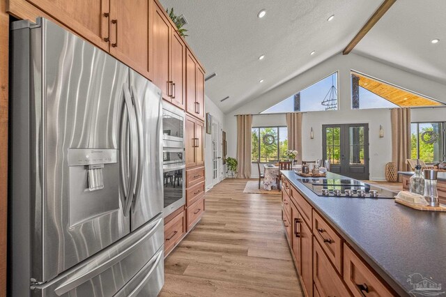 3720 Arbor Ridge Rd, Pace, FL 32571 - kitchen featuring french doors, dark countertops, beam ceiling, light wood finished floors, and stainless steel appliances