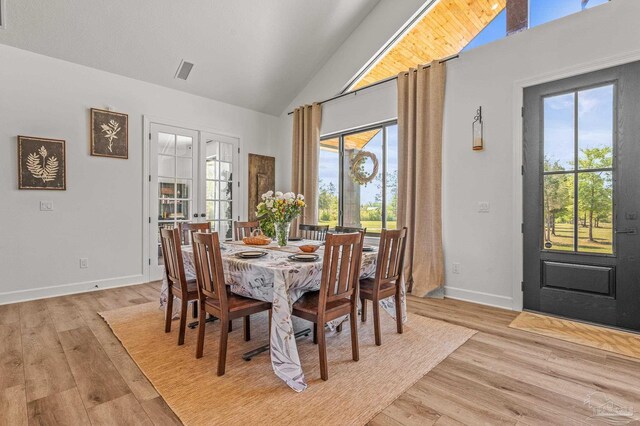 3720 Arbor Ridge Rd, Pace, FL 32571 - dining area with baseboards, high vaulted ceiling, light wood-style flooring, and a wealth of natural light