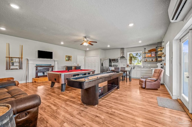 3720 Arbor Ridge Rd, Pace, FL 32571 - game room with recessed lighting, an AC wall unit, light wood finished floors, and a textured ceiling