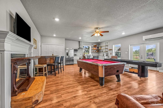 3720 Arbor Ridge Rd, Pace, FL 32571 - recreation room featuring a fireplace, billiards, a wall unit AC, and a textured ceiling
