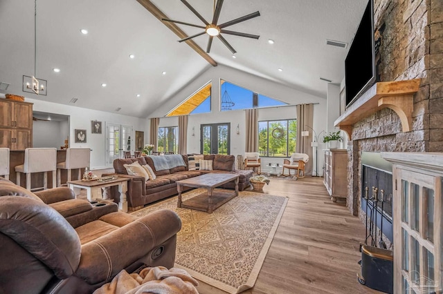 3720 Arbor Ridge Rd, Pace, FL 32571 - living area featuring visible vents, wood finished floors, a fireplace, high vaulted ceiling, and ceiling fan with notable chandelier