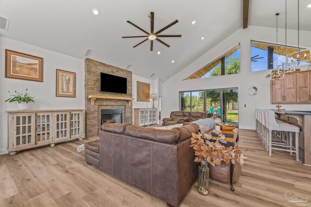 3720 Arbor Ridge Rd, Pace, FL 32571 - living room featuring beam ceiling, light wood-style floors, high vaulted ceiling, a stone fireplace, and a ceiling fan