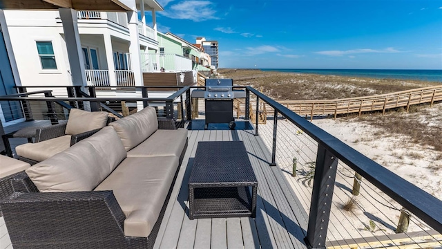 balcony featuring grilling area, a view of the beach, a water view, and an outdoor hangout area