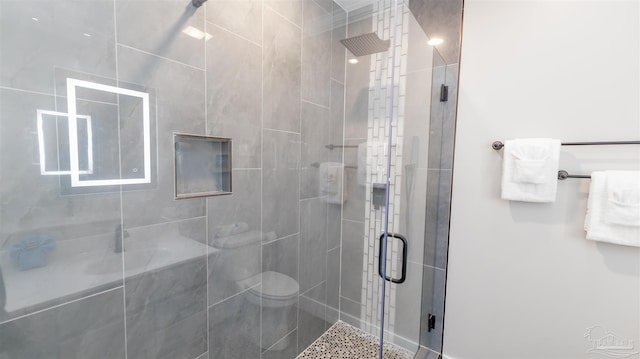 bathroom with an enclosed shower and toilet