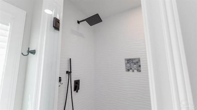 bathroom with a tile shower