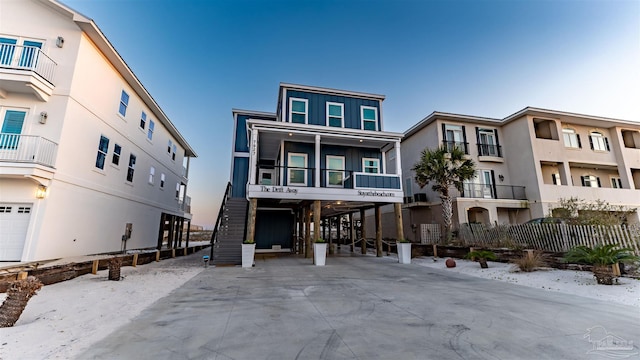 view of front of property with a balcony and a carport