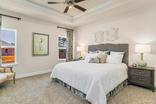 bedroom featuring ceiling fan, light colored carpet, a raised ceiling, and ornamental molding