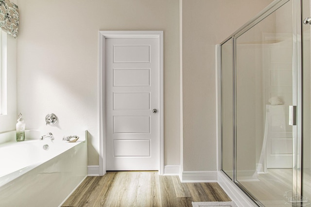 bathroom with wood-type flooring and plus walk in shower