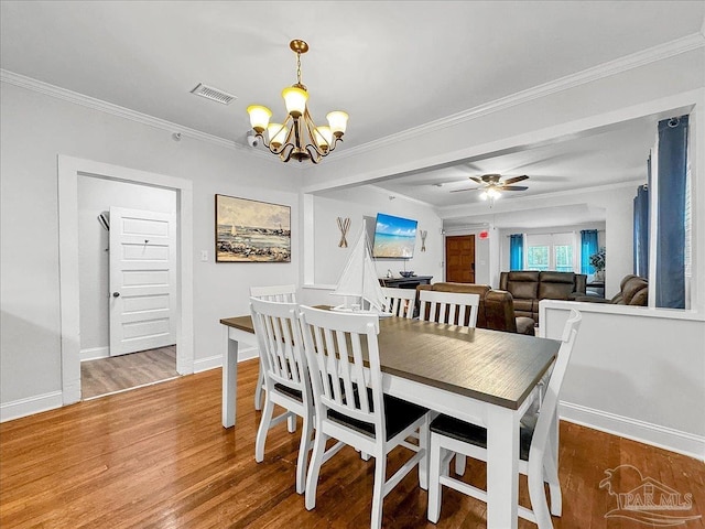 1007 W Wright St, Pensacola, FL 32501 - dining area featuring wood finished floors, ceiling fan with notable chandelier, baseboards, visible vents, and ornamental molding