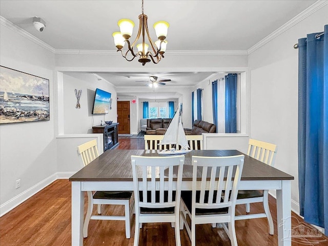1007 W Wright St, Pensacola, FL 32501 - dining room with ceiling fan with notable chandelier, wood finished floors, baseboards, and ornamental molding
