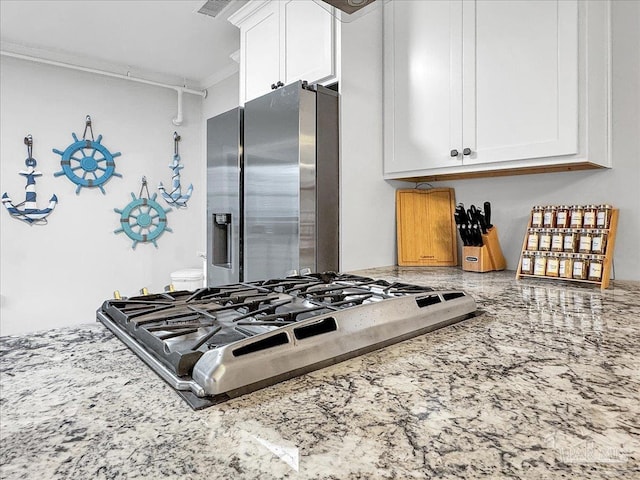 1007 W Wright St, Pensacola, FL 32501 - kitchen featuring white cabinets, stainless steel fridge with ice dispenser, crown molding, and light stone counters