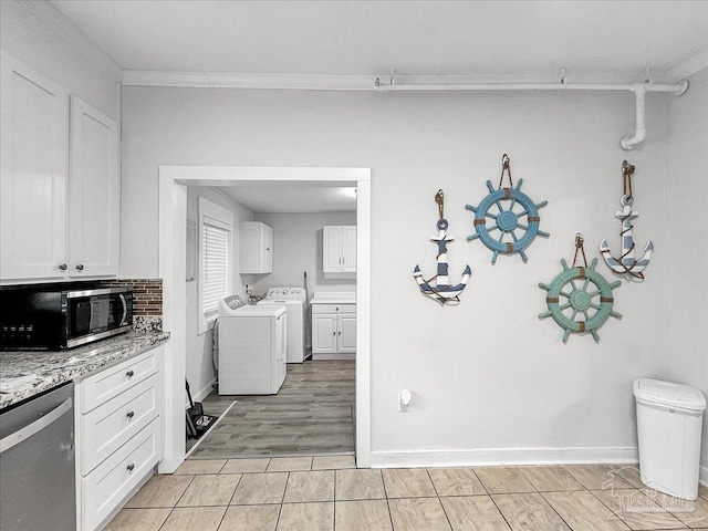 1007 W Wright St, Pensacola, FL 32501 - kitchen with white cabinets, crown molding, separate washer and dryer, and stainless steel dishwasher