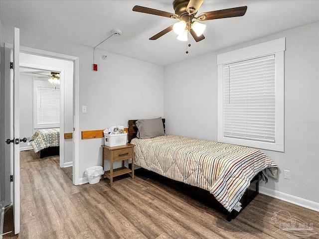 1007 W Wright St, Pensacola, FL 32501 - bedroom with baseboards, wood finished floors, and a ceiling fan