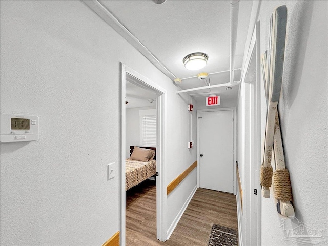 1007 W Wright St, Pensacola, FL 32501 - hallway with baseboards, wood finished floors, and a textured wall