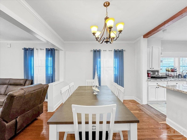 1007 W Wright St, Pensacola, FL 32501 - dining room featuring baseboards, a notable chandelier, light wood-style floors, and ornamental molding