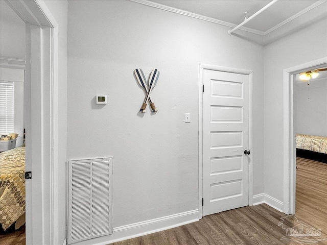 1007 W Wright St, Pensacola, FL 32501 - hallway featuring dark wood finished floors, baseboards, visible vents, and crown molding