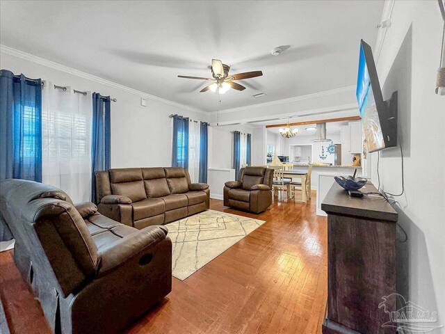 1007 W Wright St, Pensacola, FL 32501 - living area with ceiling fan with notable chandelier, wood finished floors, and ornamental molding