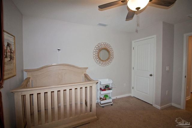 9453 Lutoo Ln, Pensacola, FL 32526 - carpeted bedroom featuring a nursery area, baseboards, and ceiling fan
