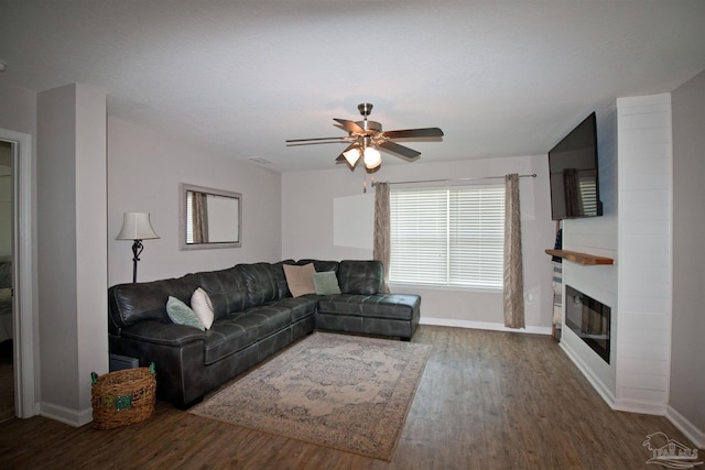 9453 Lutoo Ln, Pensacola, FL 32526 - living room with wood finished floors, baseboards, ceiling fan, and a large fireplace
