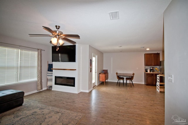 9453 Lutoo Ln, Pensacola, FL 32526 - living area featuring wood finished floors, a glass covered fireplace, healthy amount of natural light, baseboards, and recessed lighting