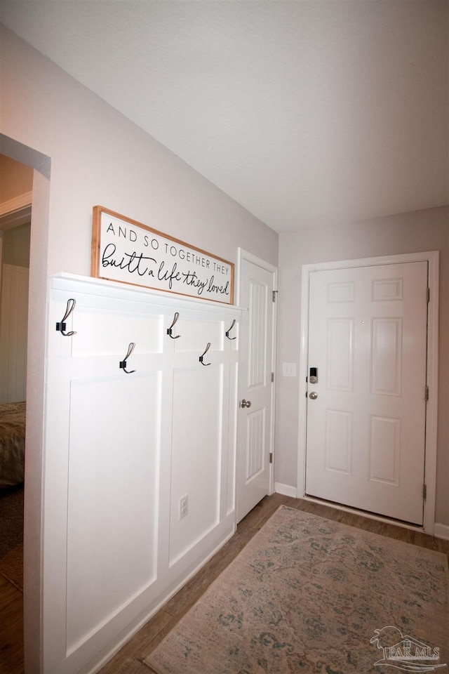 9453 Lutoo Ln, Pensacola, FL 32526 - mudroom featuring baseboards and wood finished floors