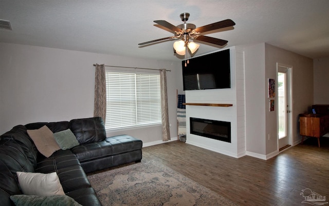 9453 Lutoo Ln, Pensacola, FL 32526 - living area featuring wood finished floors, a ceiling fan, baseboards, and a large fireplace