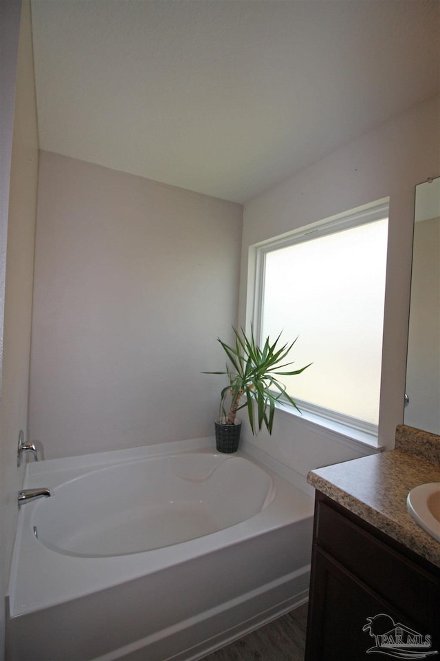 9453 Lutoo Ln, Pensacola, FL 32526 - full bathroom with vanity, a garden tub, and wood finished floors
