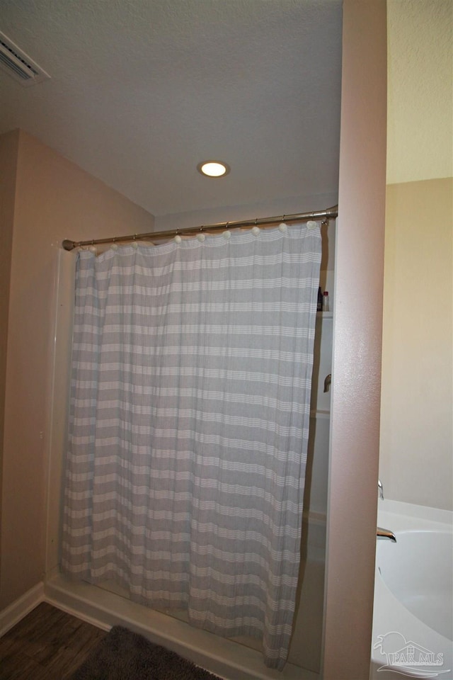 9453 Lutoo Ln, Pensacola, FL 32526 - bathroom featuring wood finished floors, recessed lighting, and a shower with shower curtain