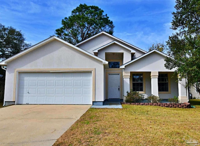 view of front of house featuring a front yard and a garage