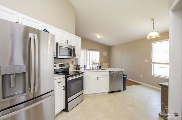 kitchen with white cabinetry, hanging light fixtures, vaulted ceiling, stainless steel appliances, and sink