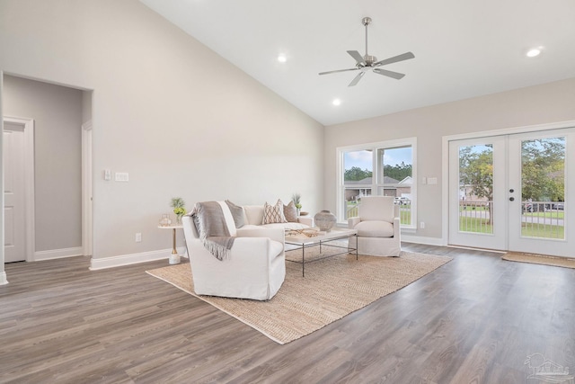 living room featuring dark hardwood / wood-style flooring, high vaulted ceiling, french doors, and ceiling fan