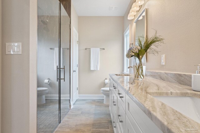 bathroom with double vanity and toilet