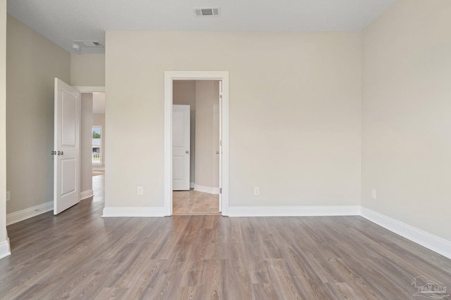 empty room with wood-type flooring