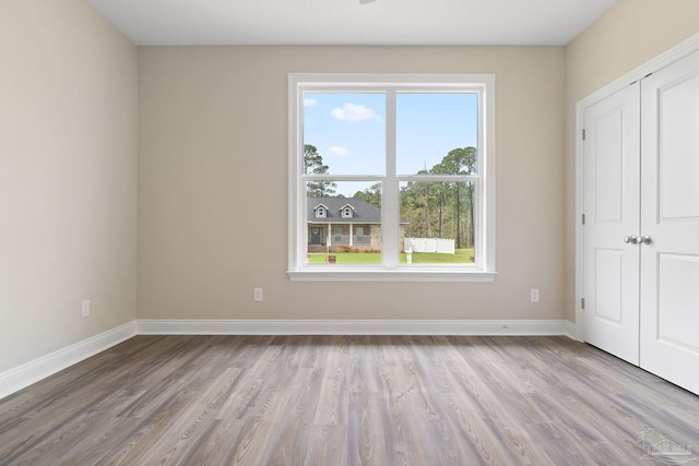 unfurnished bedroom with a closet and wood-type flooring