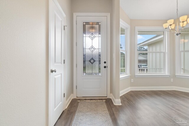 interior space featuring an inviting chandelier and dark hardwood / wood-style floors