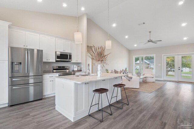 kitchen featuring white cabinets, stainless steel appliances, light hardwood / wood-style flooring, and sink