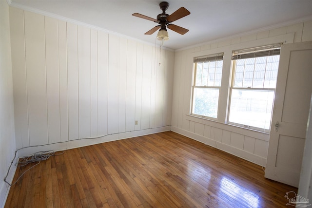 unfurnished room with hardwood / wood-style flooring, ceiling fan, and ornamental molding