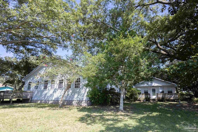 exterior space featuring a front yard and a deck