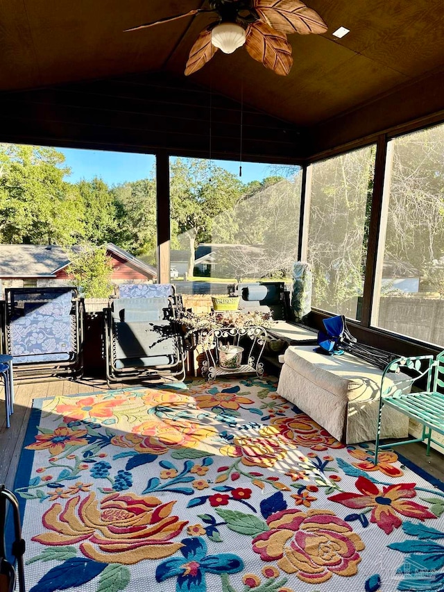 sunroom with ceiling fan and lofted ceiling