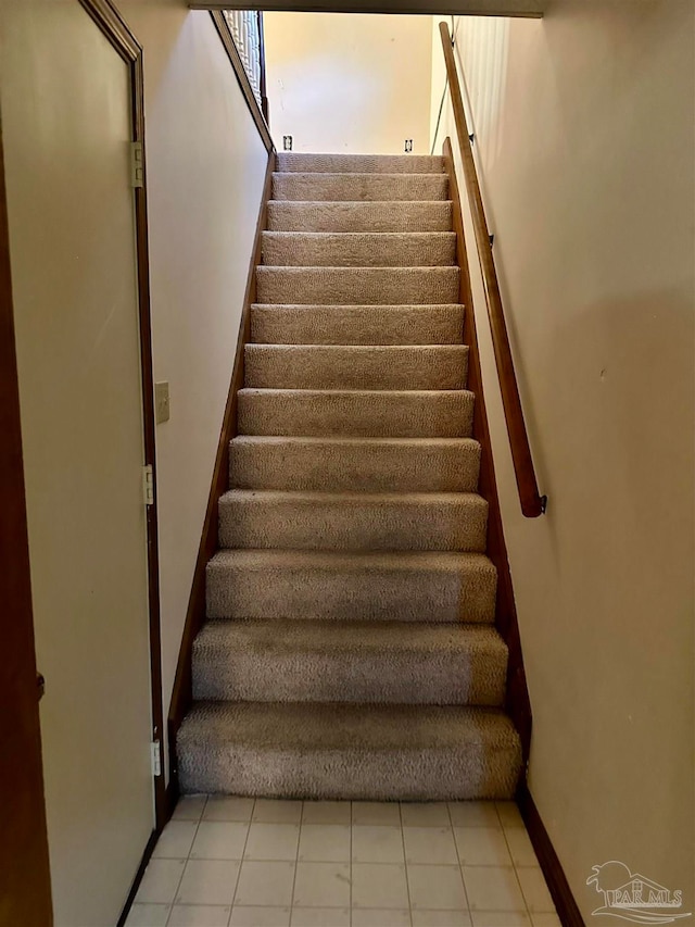 stairs with tile patterned flooring