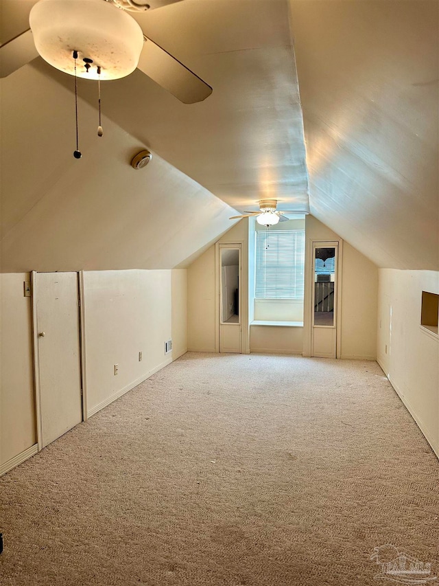 bonus room featuring carpet floors and vaulted ceiling