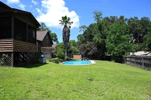 view of yard with a fenced in pool and a sunroom